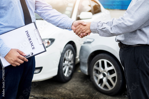 Customer shake hand with auto insurance agents after agreeing to terms of insurance