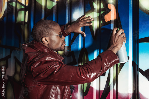 african american man painting graffiti