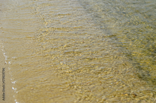 Soft waves on a sandy beach
