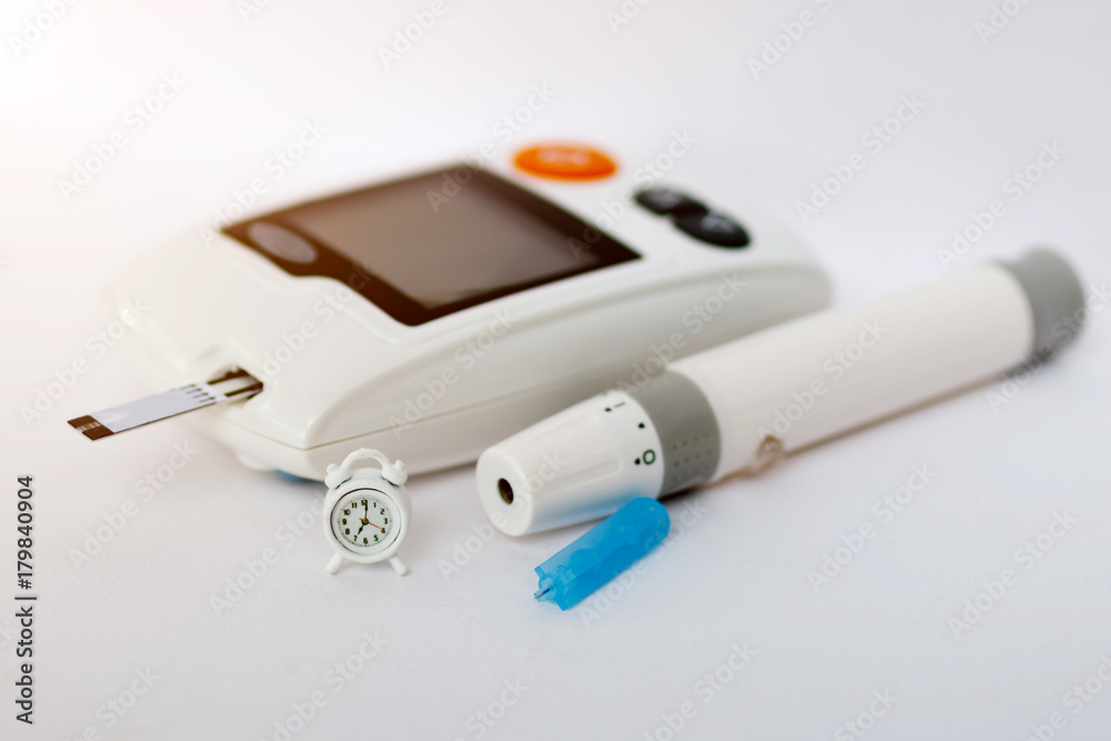 Glucose meter of diabetes and miniature clock , Time to check diabetes and health care concept. Glucose meter of diabetes and miniature clock , Time to check diabetes and health care concept.