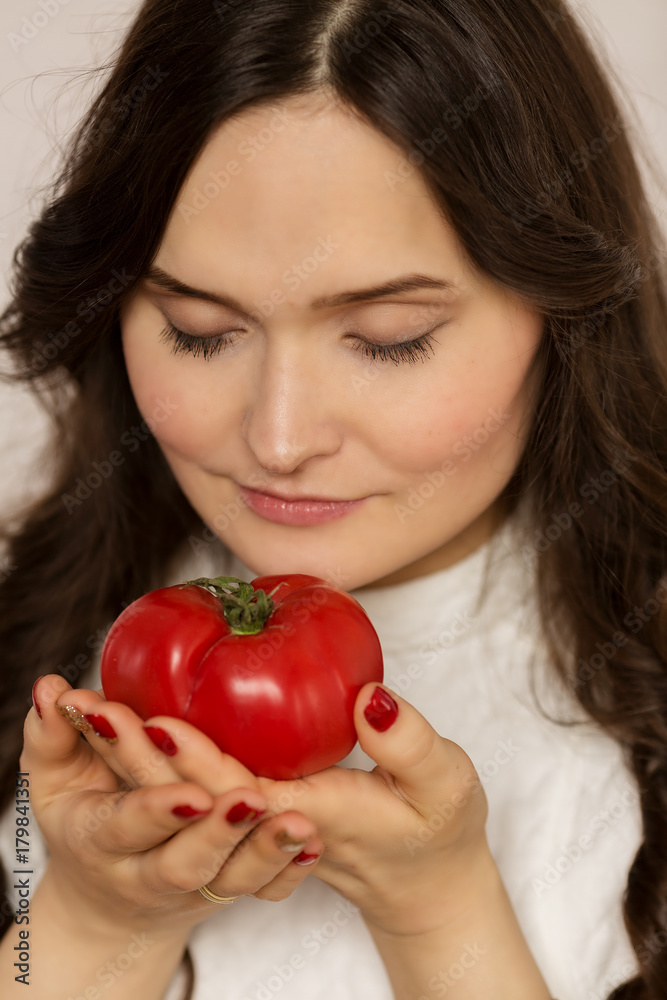 Young beautiful woman, brunette, with fruit in hands Young beautiful woman, brunette, with fruit in hands