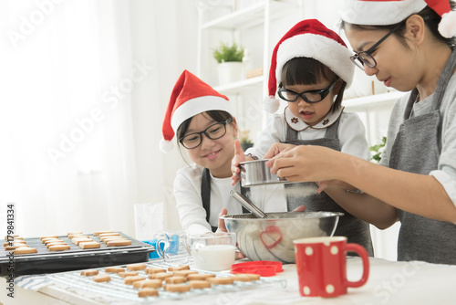 Asian family baking cookies in the kitchen.