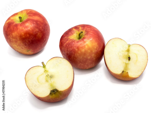 Red Kanzi apples, two whole, two halves, isolated on white background