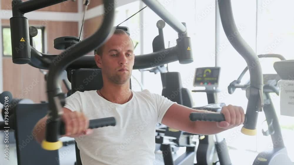 Young Muscular Man Doing Exercise On Chest Press Machine gym. Young Muscular Man Doing Exercise On Chest Press Machine gym.