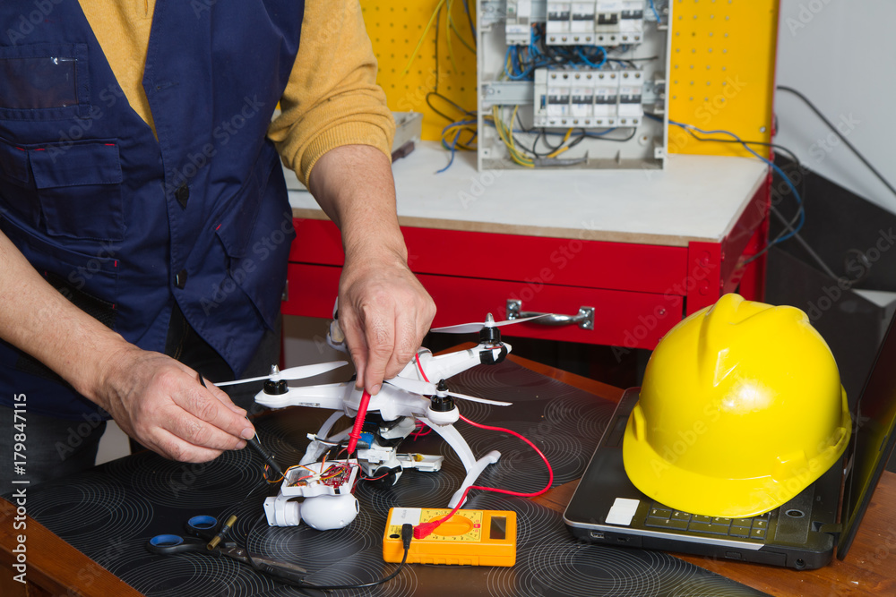 Fototapeta premium electrician fitting a quadcopter