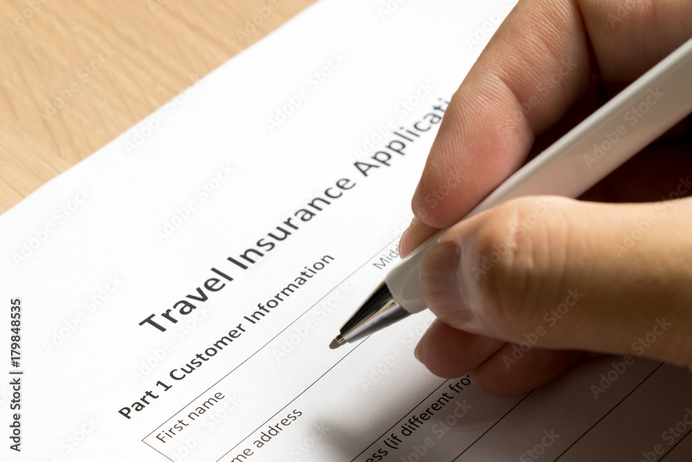 Man wait to fill information in travel insurance application form on desk background Man wait to fill information in travel insurance application form on desk background