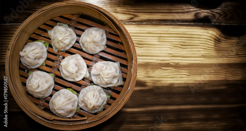 Delicious Taiwanese Styled Steamed Xiaolongbao in Bamboo Steamer photo