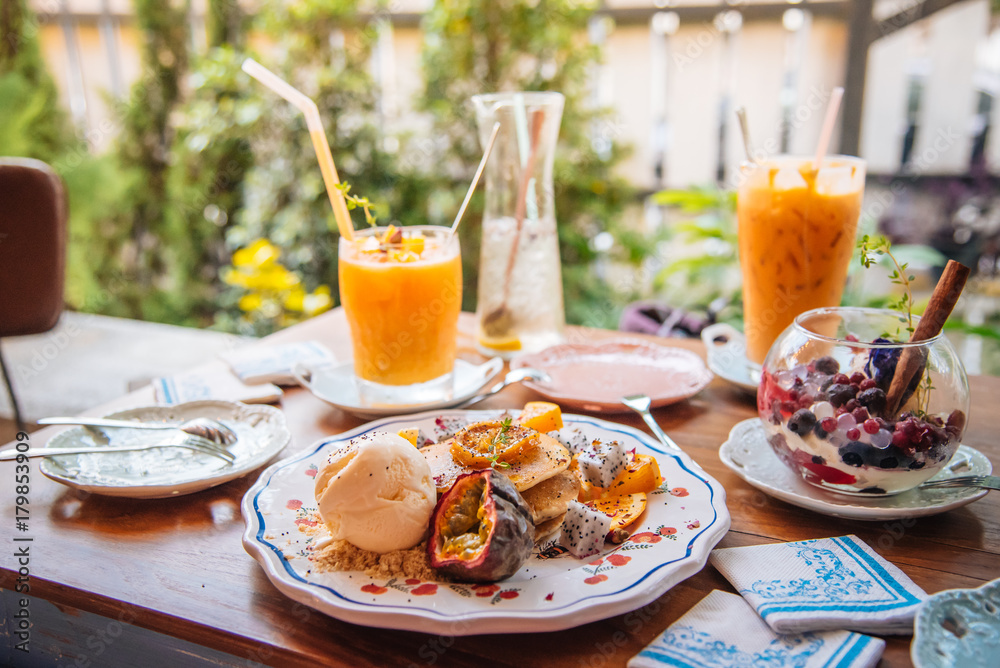 Sweet Pancakes with honey and vanilla ice cream Fruit with Orange focus on pancake