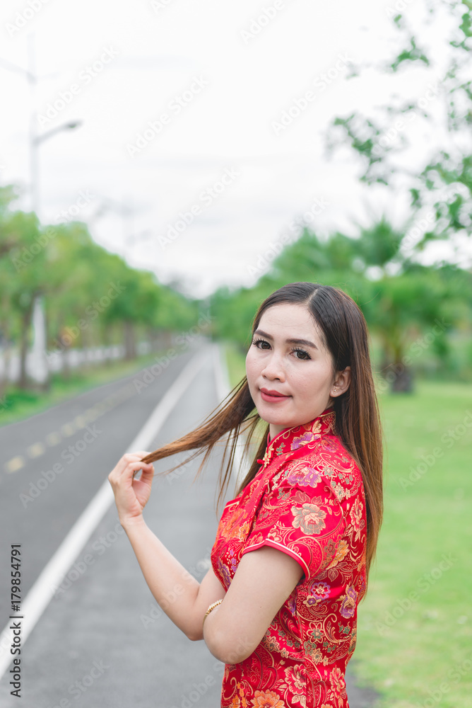 happy Chinese new year. Asian woman wearing traditional Cheongsam clothes portrait outdoor happy Chinese new year. Asian woman wearing traditional Cheongsam clothes portrait outdoor