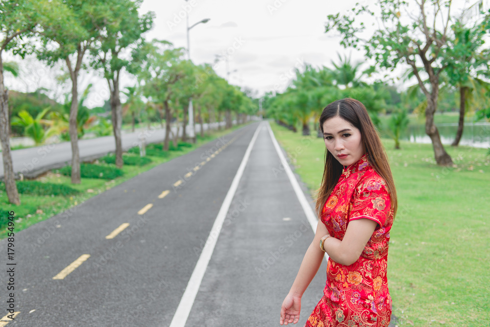 happy Chinese new year. Asian woman wearing traditional Cheongsam clothes portrait outdoor happy Chinese new year. Asian woman wearing traditional Cheongsam clothes portrait outdoor