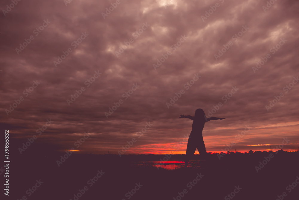 Silhouette of asian woman play yoga on sunset