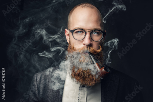 A man smoking pipe over gre...
