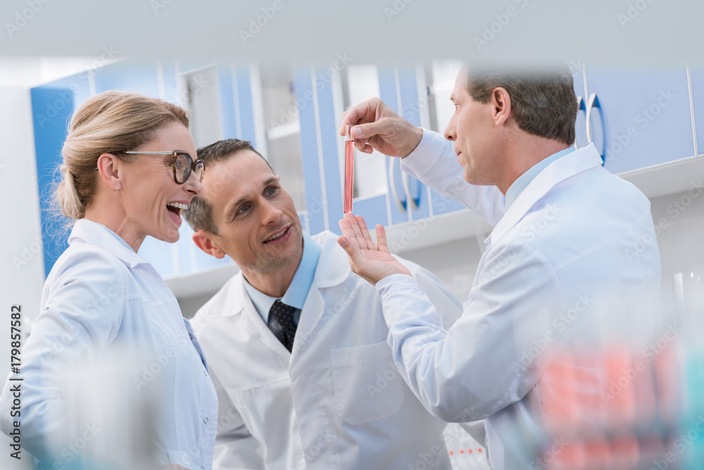 Scientists examining test tube Scientists examining test tube