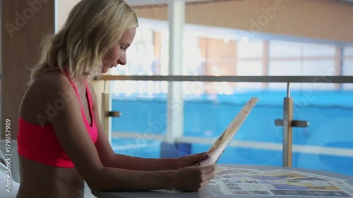 sporty girl reading a newspaper photo