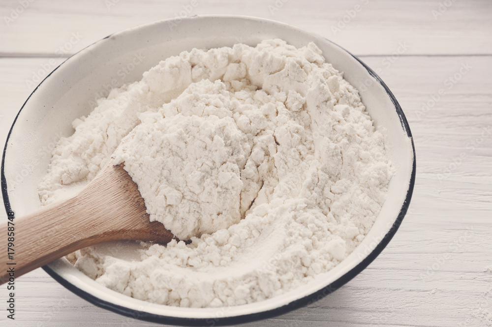 Making dough, baking. Bowl with flour on wood desk Making dough, baking. Bowl with flour on wood desk