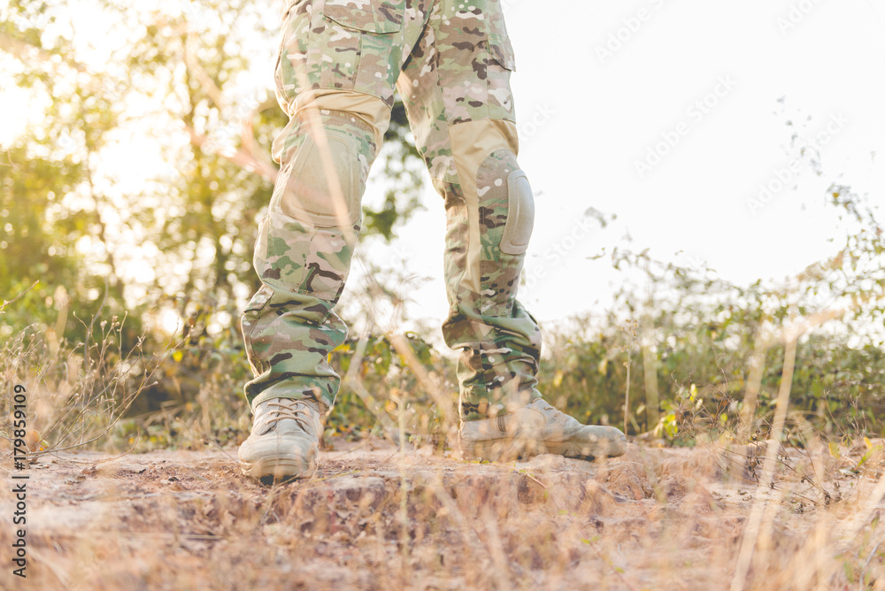 Soldier standby on the mountain with flare and bright sunlight