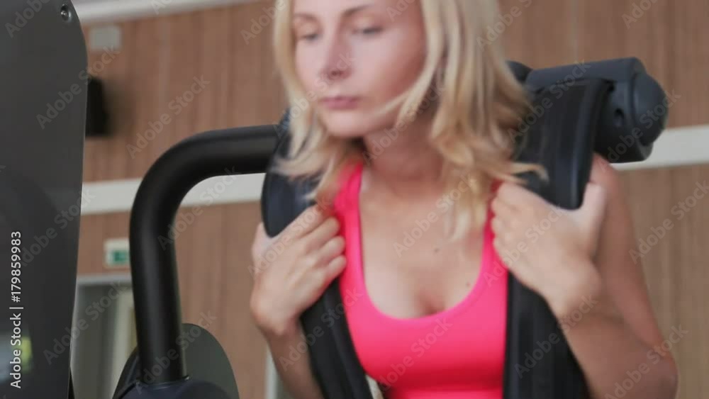 Beautiful girl swings the press in gym Beautiful girl swings the press in gym