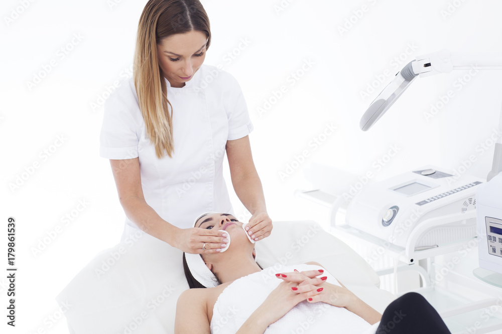 Young woman in beautician having a facial cleaning.