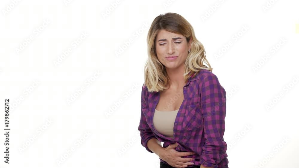 copy space portrait of adult sick woman touching stomach menstruation pain suffering from cramps having over white background in studio. Concept of emotions copy space portrait of adult sick woman touching stomach menstruation pain suffering from cramps having over white background in studio. Concept of emotions