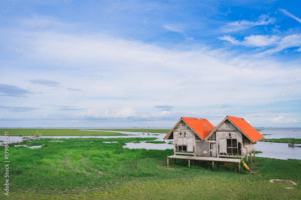 Twin hut with green field in Thalay Noi Waterfowl Park, Phatthalung, Thailand.