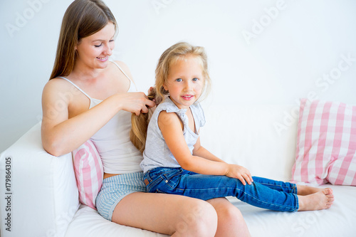 Mother and daughter taking care of hair