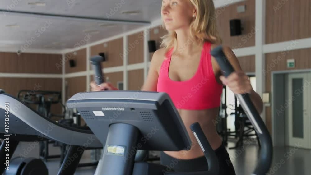 Attractive woman woman exercising on a stair stepper