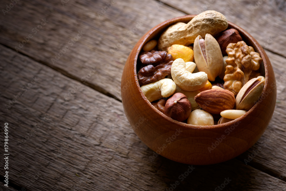Mixed nuts in wooden bowl Mixed nuts in wooden bowl