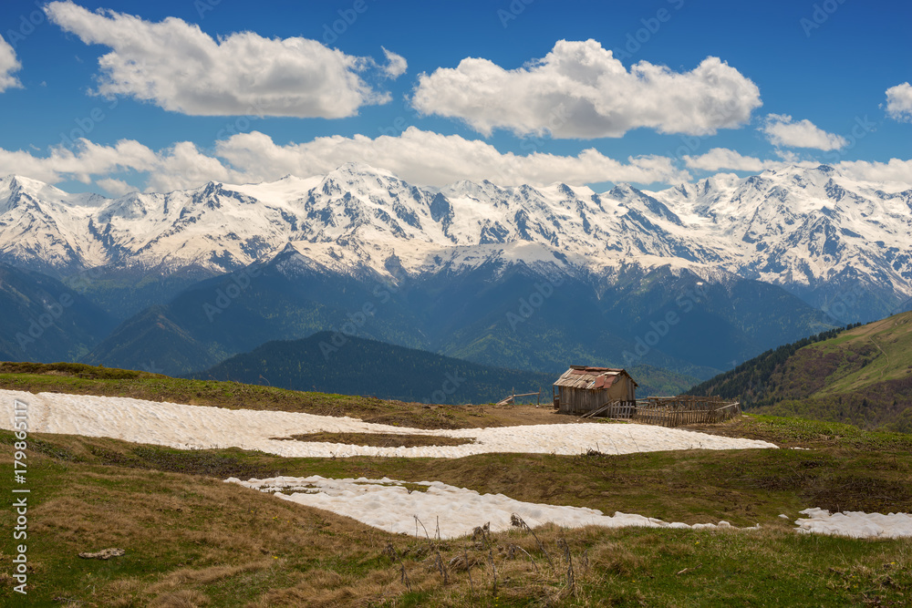 Old hut of shepherds on the background of mountain range