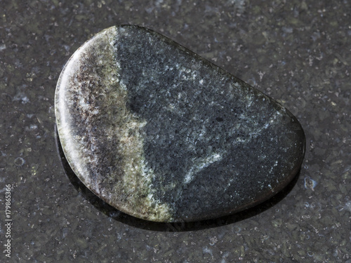 polished Olivenite stone on dark background photo