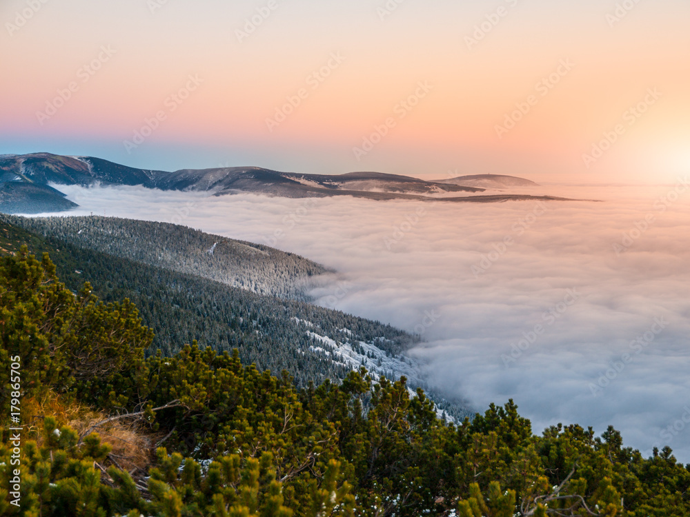 Mountain landscape at sunset time. Freezy evening and weather inversion, Giant Mountains, aka Krkonose, Czech Republic.