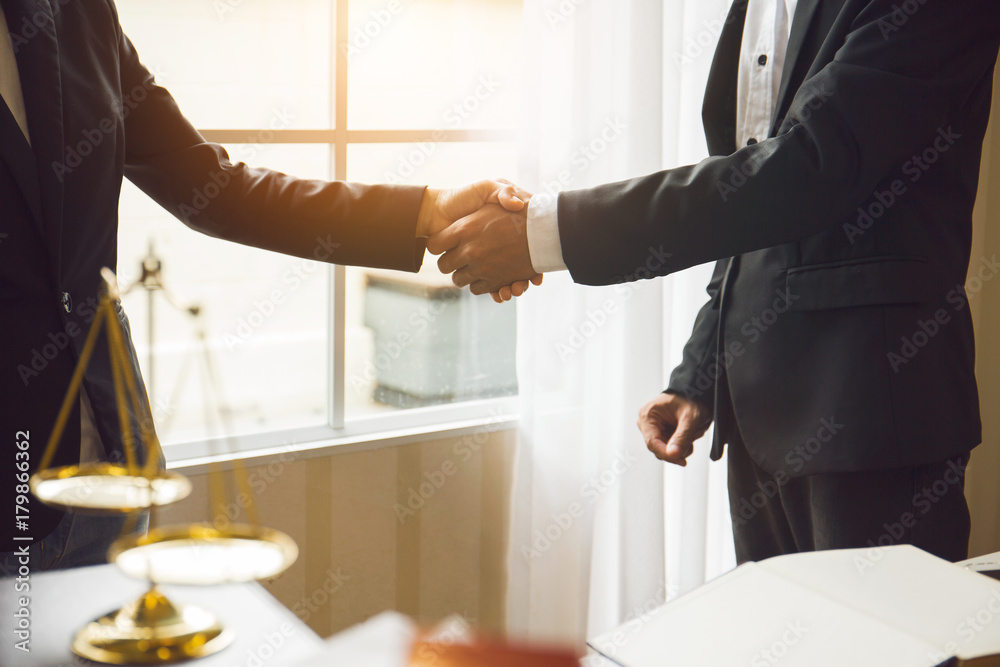 Fototapeta premium Handshake between attorneys and clients after agreeing to enter into a contract for a court case. In the hope of victory over legal fighters.