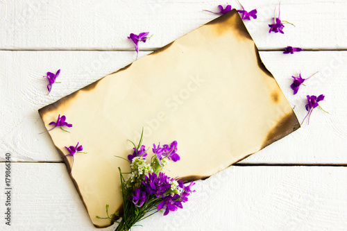 burned sheet of paper on a white wooden table