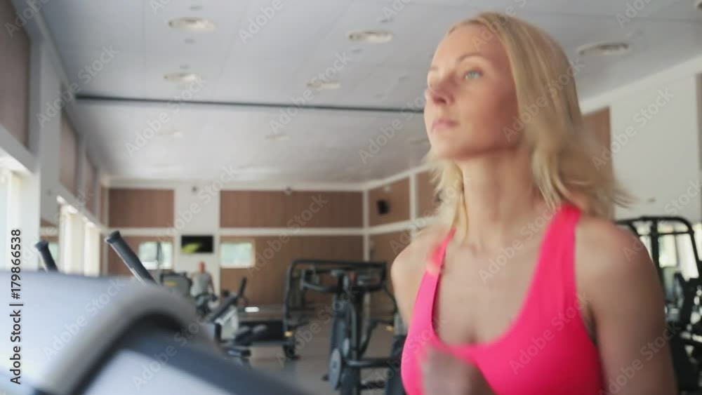 Super fit woman running on the treadmill at the gym. Super fit woman running on the treadmill at the gym.
