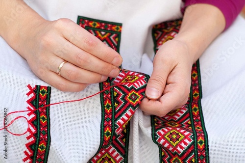 Female hand embroider at cross