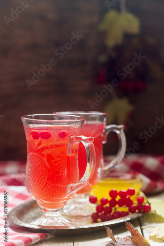 Useful vitamin tea from berries of the viburnum with honey with glass cups.