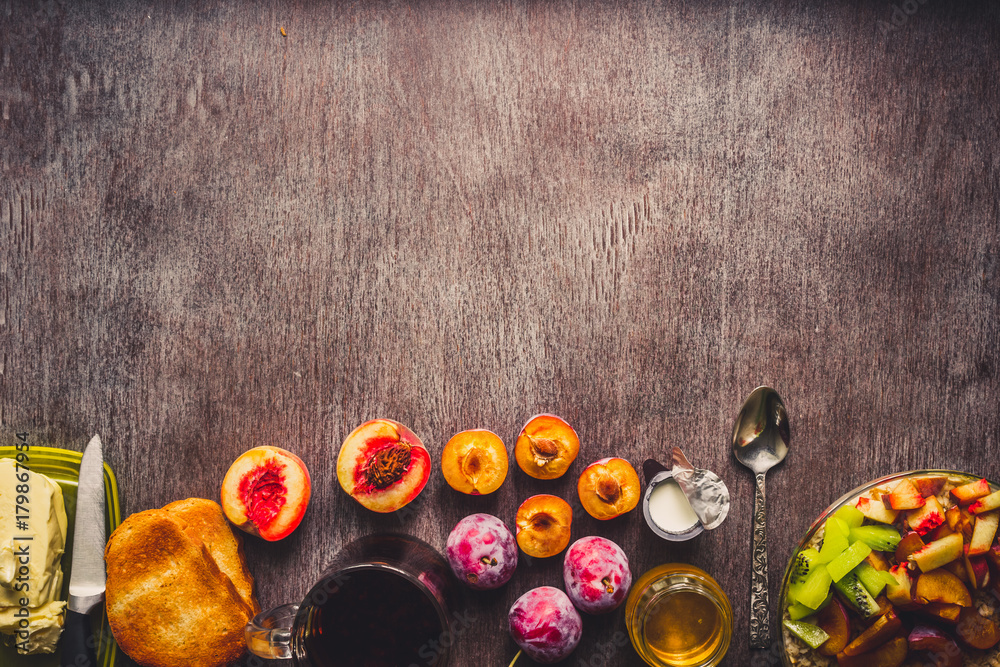 Healthy breakfast with oatmeal in a glass bowl and fruit on table. Toned Healthy breakfast with oatmeal in a glass bowl and fruit on table. Toned