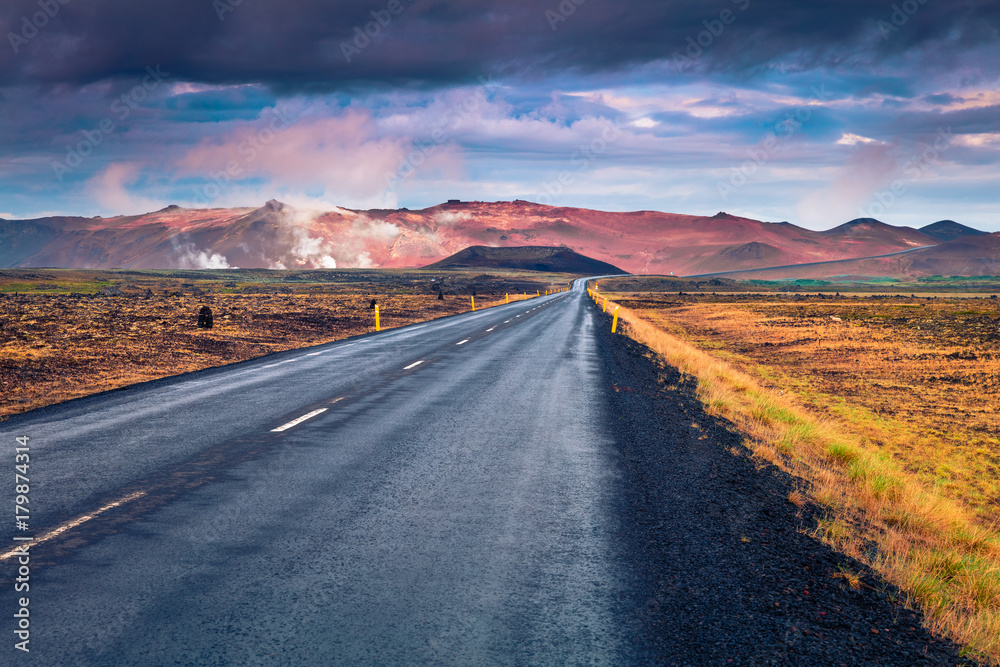 Empty asphalt road with colorful cloudy sky.