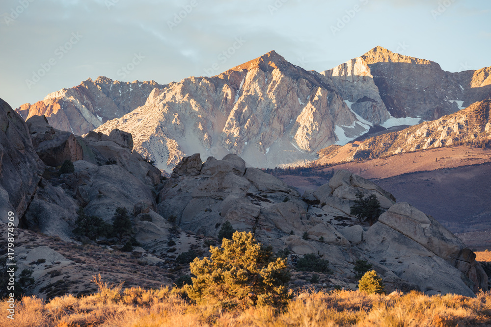 Early morning sunrise in fall hits the mountains of the eastern Sierra Nevada near Bishop, California