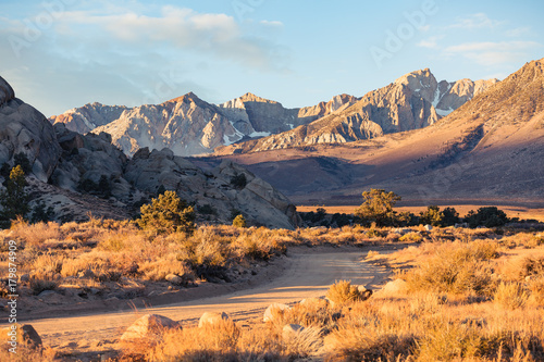 Early morning sunrise in fall hits the mountains of the eastern Sierra Nevada near Bishop, California