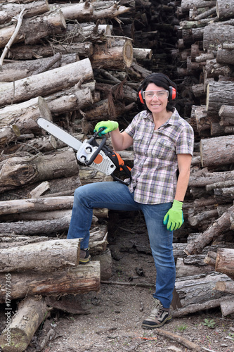 portrait of a woman with a chainsaw
