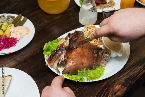 Man eats tasty dish of pork...