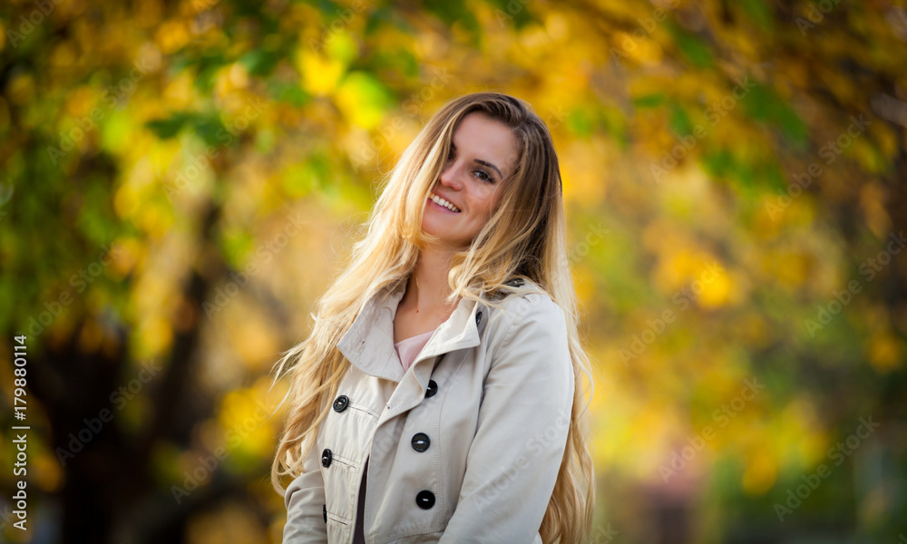 Cheerful woman walking in the city under colorful autumn trees 2 Cheerful woman walking in the city under colorful autumn trees 2