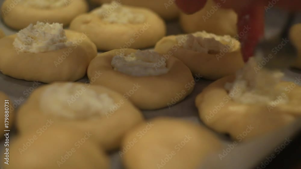girl makes of buns on the table, hands, close-up girl makes of buns on the table, hands, close-up