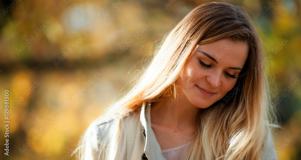 Smiling girl in coat on autumn background at sunny day Smiling girl in coat on autumn background at sunny day