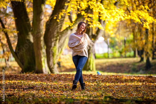 Enjoy autumn happy woman on colorful fall background