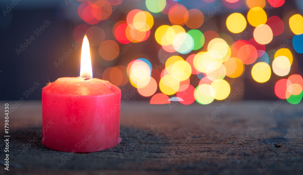 Christmas Candle over blurred christmas Bokeh background,Space for text. Christmas Candle over blurred christmas Bokeh background,Space for text.