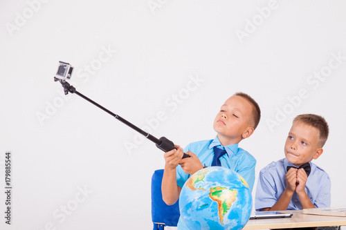 the two boys are photographed at the school at the table photo