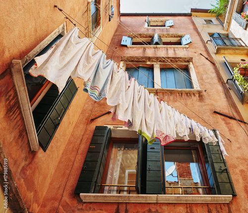 Underwear drying on the rope in the old yard in Italy
