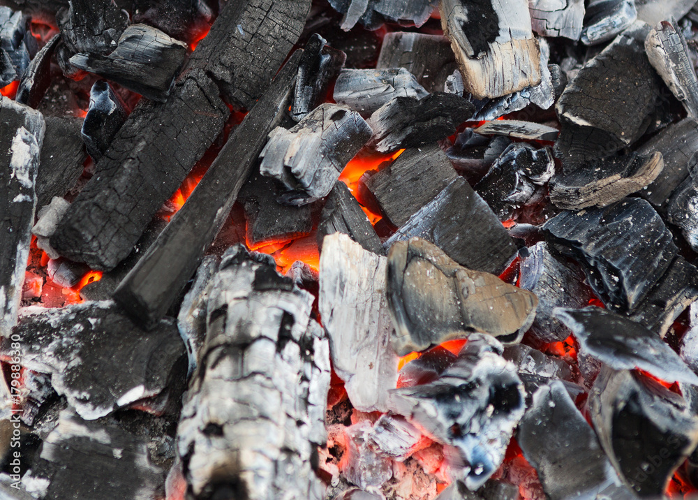 Burning and glowing charcoal with open hot flame and smoke close up. Burning and glowing charcoal with open hot flame and smoke close up.
