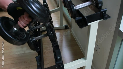 Closeup of a muscular young man lifting weights